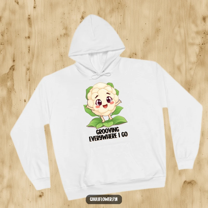 Funny hoodie of a cauliflower with big, eager eyes doing a funny jig on a bed of leaves, perfect for laughs.